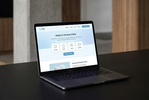 High-quality professional laptop mockup on a clean, dark surface. The laptop screen displays a modern website.